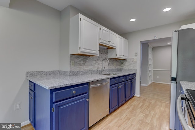 2 Rainflower Path Unit 102, Sparks Glencoe, MD 21152 - kitchen featuring appliances with stainless steel finishes, a sink, blue cabinetry, decorative backsplash, and white cabinetry