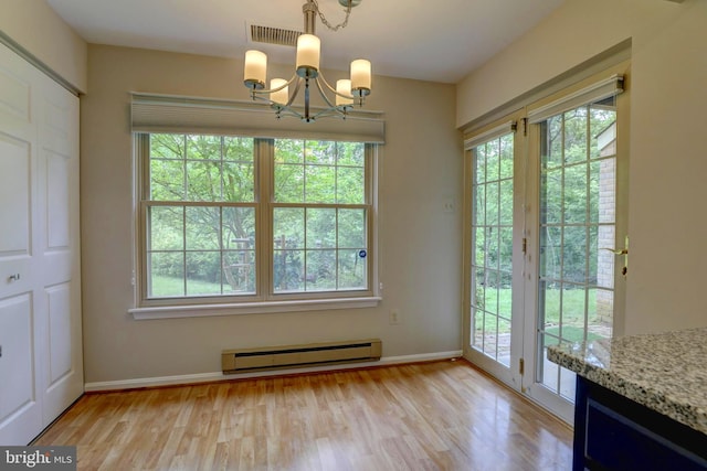 2 Rainflower Path Unit 102, Sparks Glencoe, MD 21152 - unfurnished dining area featuring a baseboard radiator, a chandelier, light wood finished floors, and baseboards