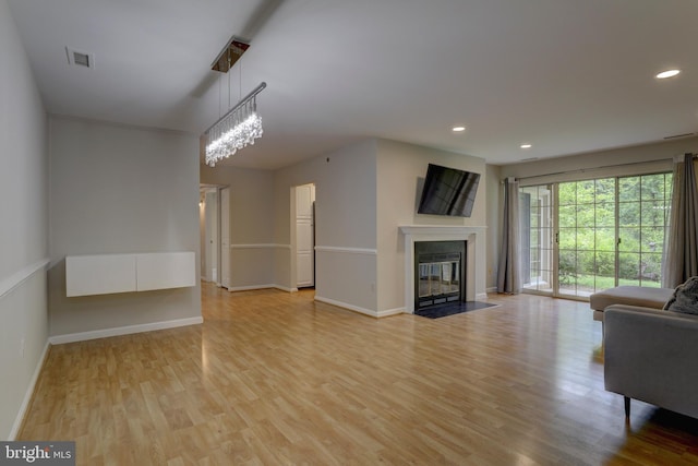 2 Rainflower Path Unit 102, Sparks Glencoe, MD 21152 - unfurnished living room with light wood-type flooring, baseboards, a fireplace with flush hearth, and recessed lighting