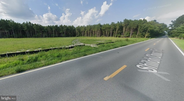 view of road featuring a wooded view