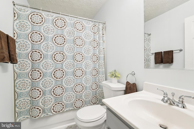 bathroom featuring toilet, a textured ceiling, vanity, and curtained shower