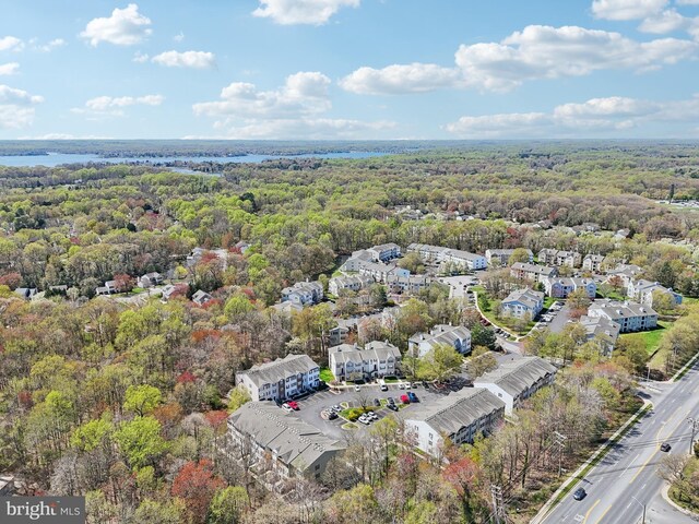 birds eye view of property with a forest view and a water view