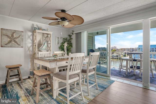 107 Convention Center Dr Unit 161D, Ocean City, MD 21842 - dining space featuring a water view, a textured ceiling, crown molding, wood finished floors, and a ceiling fan