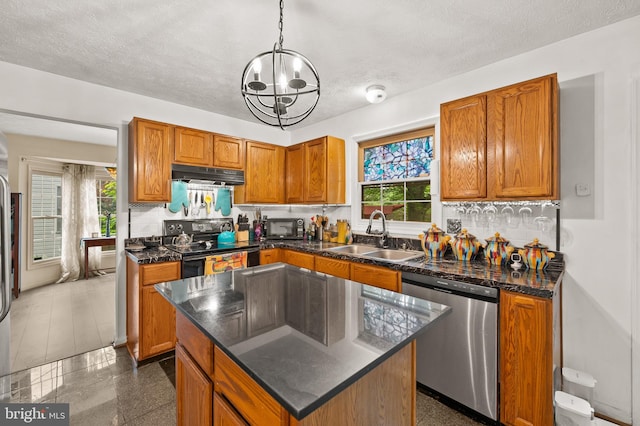 9525 Queens Guard Ct, Laurel, MD 20723 - kitchen with black appliances, under cabinet range hood, a sink, brown cabinetry, and plenty of natural light