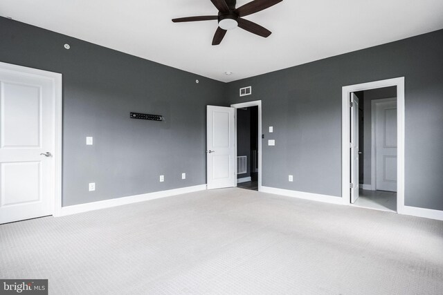 unfurnished bedroom featuring visible vents, baseboards, carpet flooring, and ceiling fan