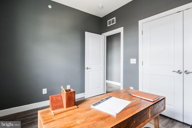 office featuring visible vents, baseboards, and wood finished floors