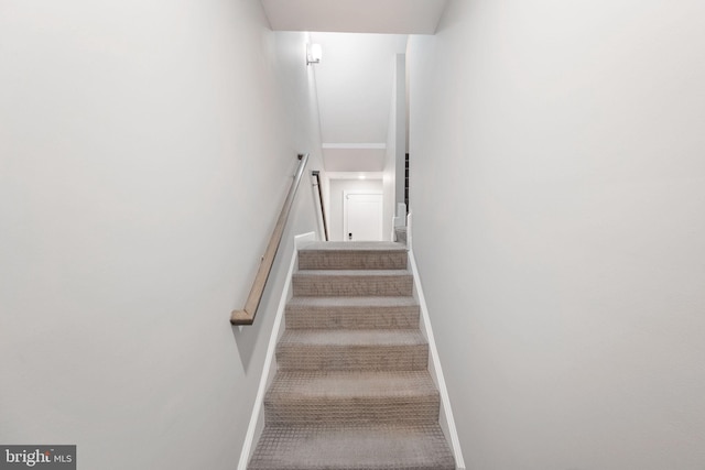 stairway featuring baseboards