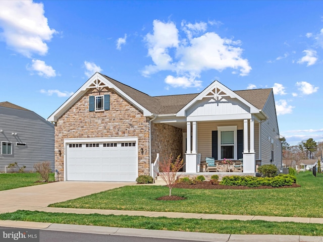 craftsman-style house featuring driveway, a front yard, covered porch, board and batten siding, and a garage