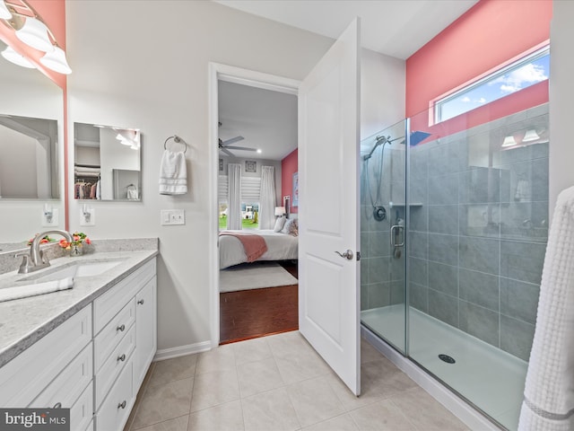 ensuite bathroom with a stall shower, vanity, tile patterned flooring, ensuite bath, and ceiling fan