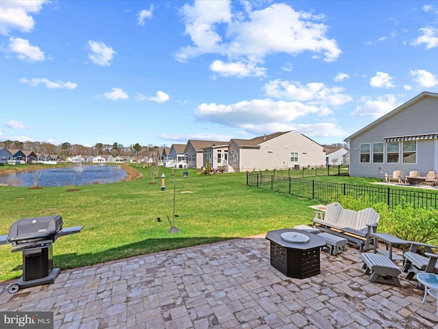 view of patio / terrace featuring a residential view, fence, and a fire pit