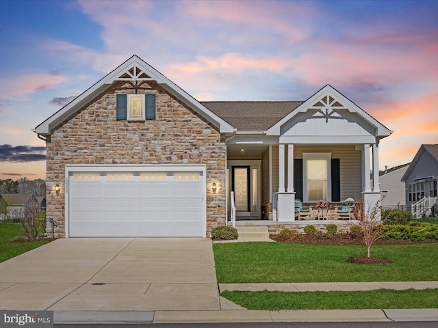 view of front of home featuring stone siding, a porch, and driveway