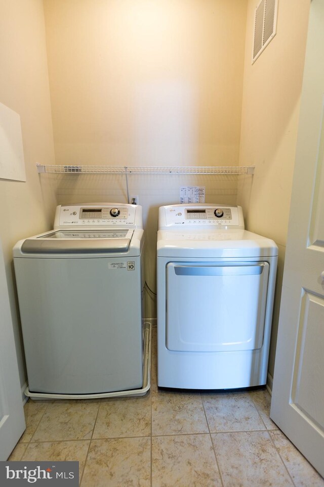 1144 Halifax Pl, Hamilton, NJ 08619 - laundry room with light tile patterned floors, washing machine and dryer, laundry area, and visible vents