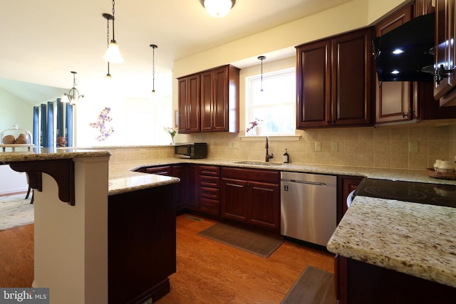 311 Treetops Dr, State College, PA 16801 - kitchen with dishwasher, a sink, a peninsula, black microwave, and wood finished floors