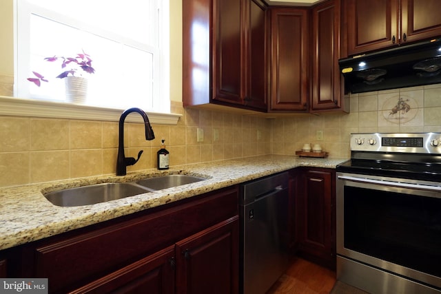 311 Treetops Dr, State College, PA 16801 - kitchen featuring tasteful backsplash, dark brown cabinets, under cabinet range hood, stainless steel appliances, and a sink