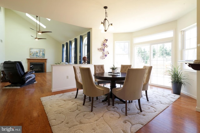 311 Treetops Dr, State College, PA 16801 - dining space with a glass covered fireplace, baseboards, wood finished floors, lofted ceiling, and ceiling fan