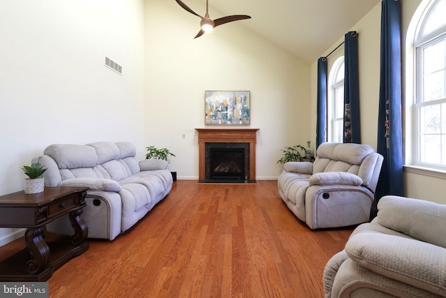 311 Treetops Dr, State College, PA 16801 - living area featuring light wood-type flooring, a fireplace with flush hearth, visible vents, ceiling fan, and high vaulted ceiling