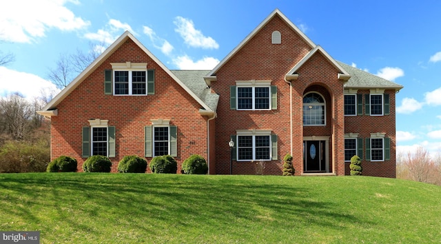 311 Treetops Dr, State College, PA 16801 - view of front facade with a shingled roof, a front yard, and brick siding
