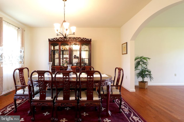 311 Treetops Dr, State College, PA 16801 - dining space featuring arched walkways, wood finished floors, baseboards, and a notable chandelier