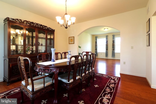 311 Treetops Dr, State College, PA 16801 - dining space with baseboards, arched walkways, a notable chandelier, and wood finished floors
