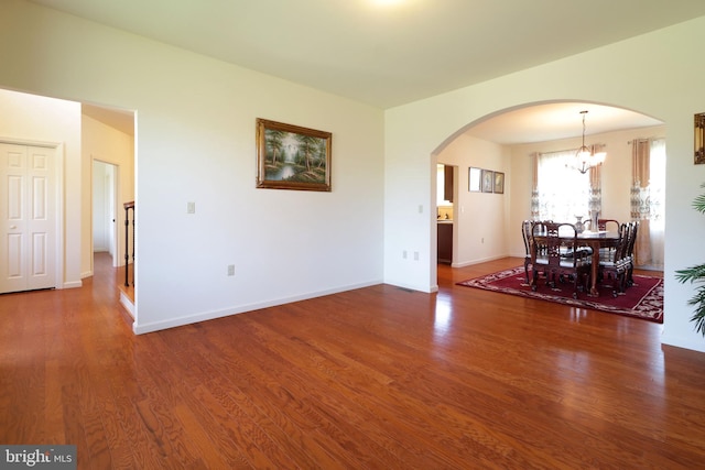 311 Treetops Dr, State College, PA 16801 - dining space with arched walkways, baseboards, an inviting chandelier, and wood finished floors