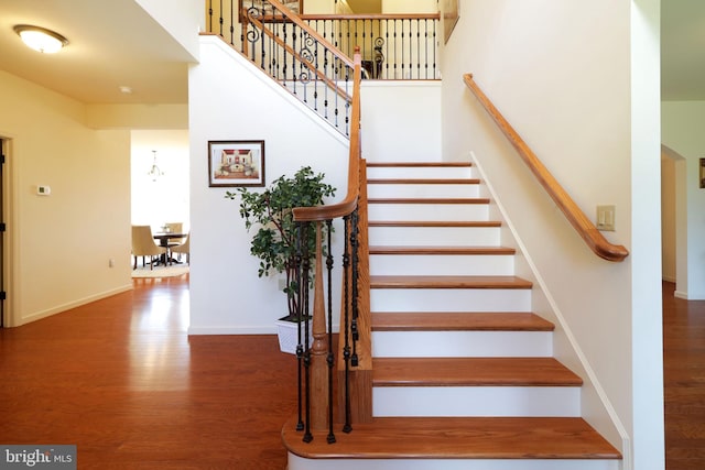 311 Treetops Dr, State College, PA 16801 - stairway with baseboards, a towering ceiling, and wood finished floors