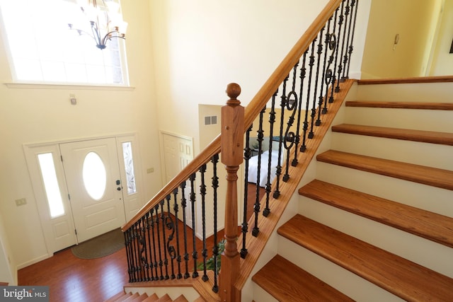 311 Treetops Dr, State College, PA 16801 - entryway featuring visible vents, baseboards, a notable chandelier, wood finished floors, and stairs