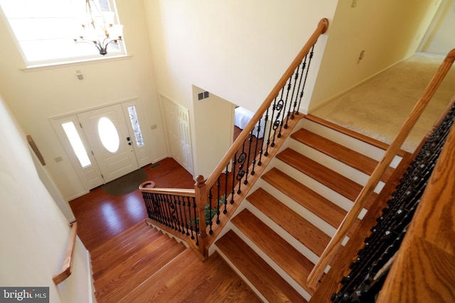 311 Treetops Dr, State College, PA 16801 - foyer entrance featuring a high ceiling, a chandelier, wood finished floors, and stairs