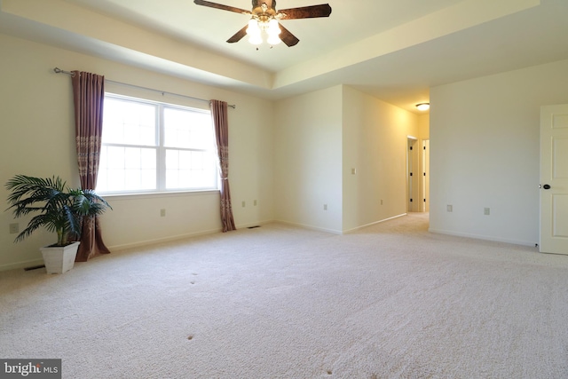 311 Treetops Dr, State College, PA 16801 - spare room featuring a tray ceiling, light colored carpet, baseboards, and ceiling fan