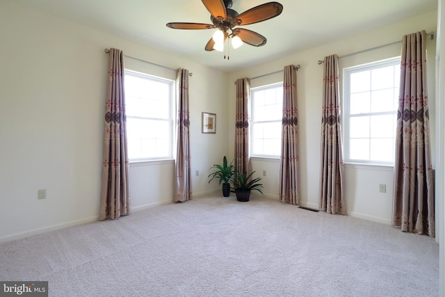 311 Treetops Dr, State College, PA 16801 - empty room with carpet flooring, ceiling fan, visible vents, and a wealth of natural light
