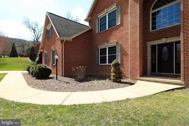 311 Treetops Dr, State College, PA 16801 - view of side of property with a shingled roof, brick siding, and a lawn