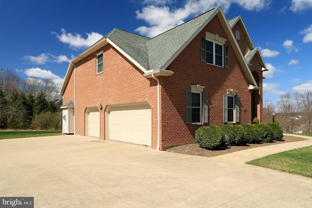 311 Treetops Dr, State College, PA 16801 - view of side of home featuring brick siding, a shingled roof, a garage, and concrete driveway