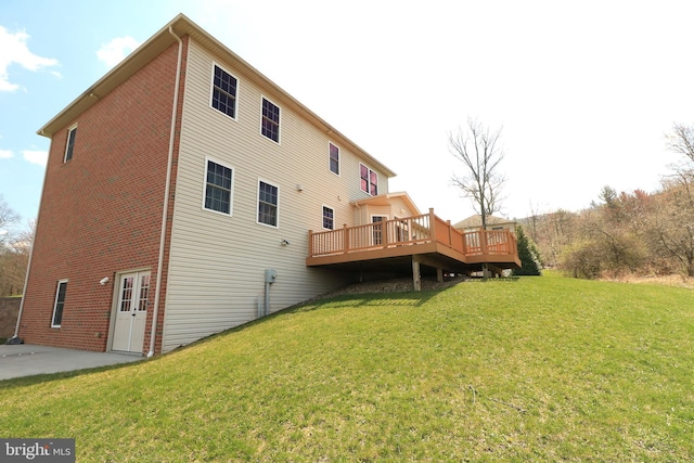311 Treetops Dr, State College, PA 16801 - rear view of house featuring brick siding, a deck, a patio, and a lawn