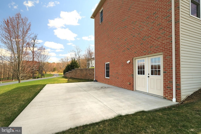 311 Treetops Dr, State College, PA 16801 - rear view of property with brick siding, a patio, and a lawn