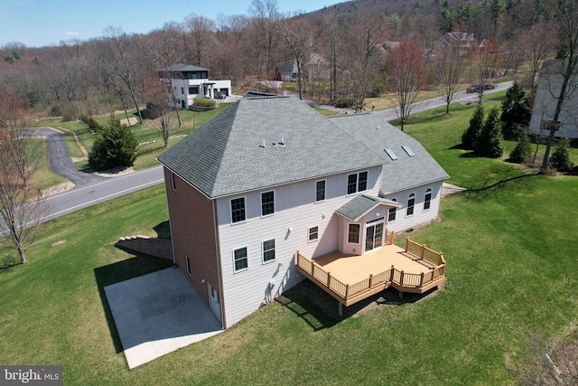 311 Treetops Dr, State College, PA 16801 - exterior space with roof with shingles, a deck, and a lawn