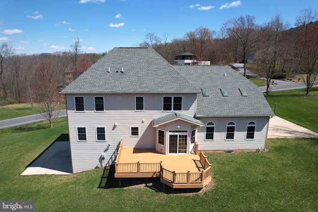 311 Treetops Dr, State College, PA 16801 - back of property featuring roof with shingles, a deck, and a lawn