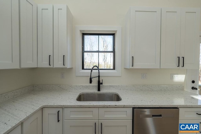 kitchen featuring a sink, white cabinets, dishwasher, and light stone counters
