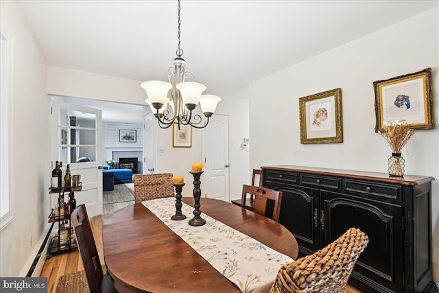 993 Hillendale Dr, Annapolis, MD 21409 - dining area with an inviting chandelier, a fireplace, a baseboard radiator, and light wood finished floors