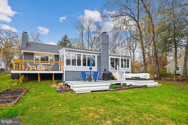 993 Hillendale Dr, Annapolis, MD 21409 - rear view of house featuring a garden, a sunroom, a chimney, a deck, and a yard