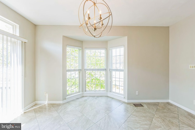 unfurnished dining area with baseboards, a notable chandelier, and visible vents
