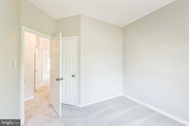 unfurnished bedroom featuring carpet floors and baseboards