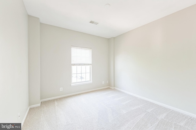 spare room featuring baseboards, carpet flooring, and visible vents