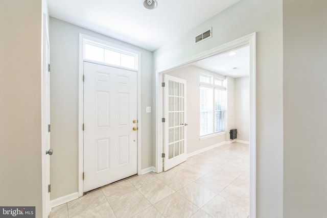 entrance foyer with light tile patterned flooring, baseboards, and visible vents