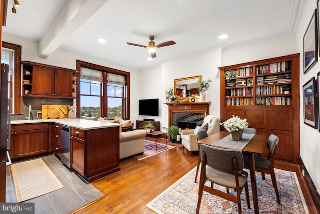 2853 Ontario Rd NW Unit 609, Washington, DC 20009 - dining room with ceiling fan, a warm lit fireplace, recessed lighting, light wood-type flooring, and beamed ceiling