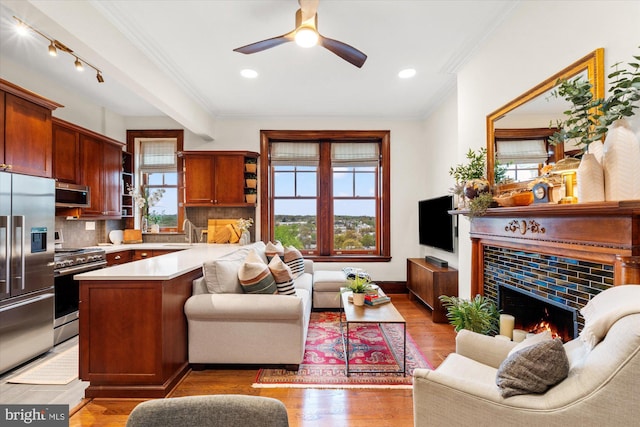 2853 Ontario Rd NW Unit 609, Washington, DC 20009 - living room with crown molding, a ceiling fan, a fireplace, light wood-style flooring, and recessed lighting