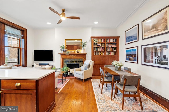 2853 Ontario Rd NW Unit 609, Washington, DC 20009 - dining space featuring light wood-type flooring, a fireplace, a ceiling fan, recessed lighting, and crown molding