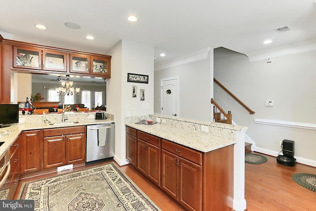 kitchen with stainless steel dishwasher, glass insert cabinets, a peninsula, a sink, and light wood finished floors