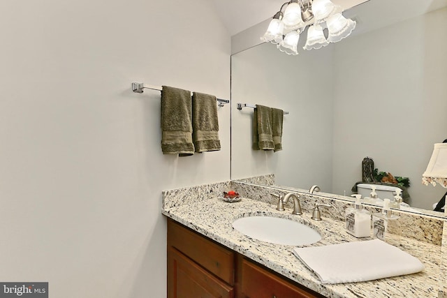 bathroom with a chandelier and vanity