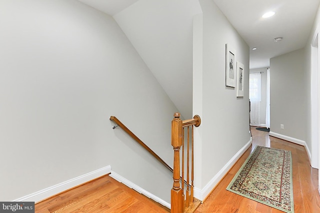 staircase with recessed lighting, baseboards, and wood finished floors