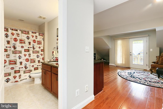 full bathroom with vanity, baseboards, toilet, visible vents, and wood finished floors