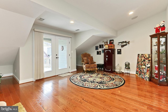 foyer with french doors, visible vents, baseboards, and wood finished floors